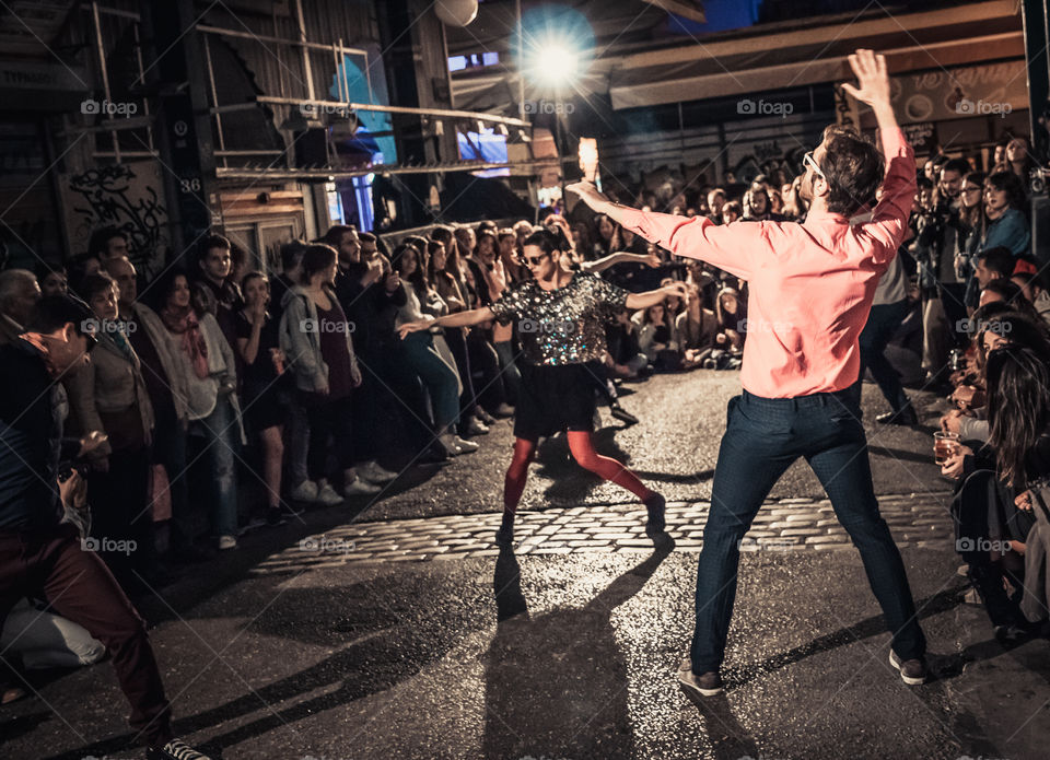 Street Dancing In The Night With Crowd Of People Watching
