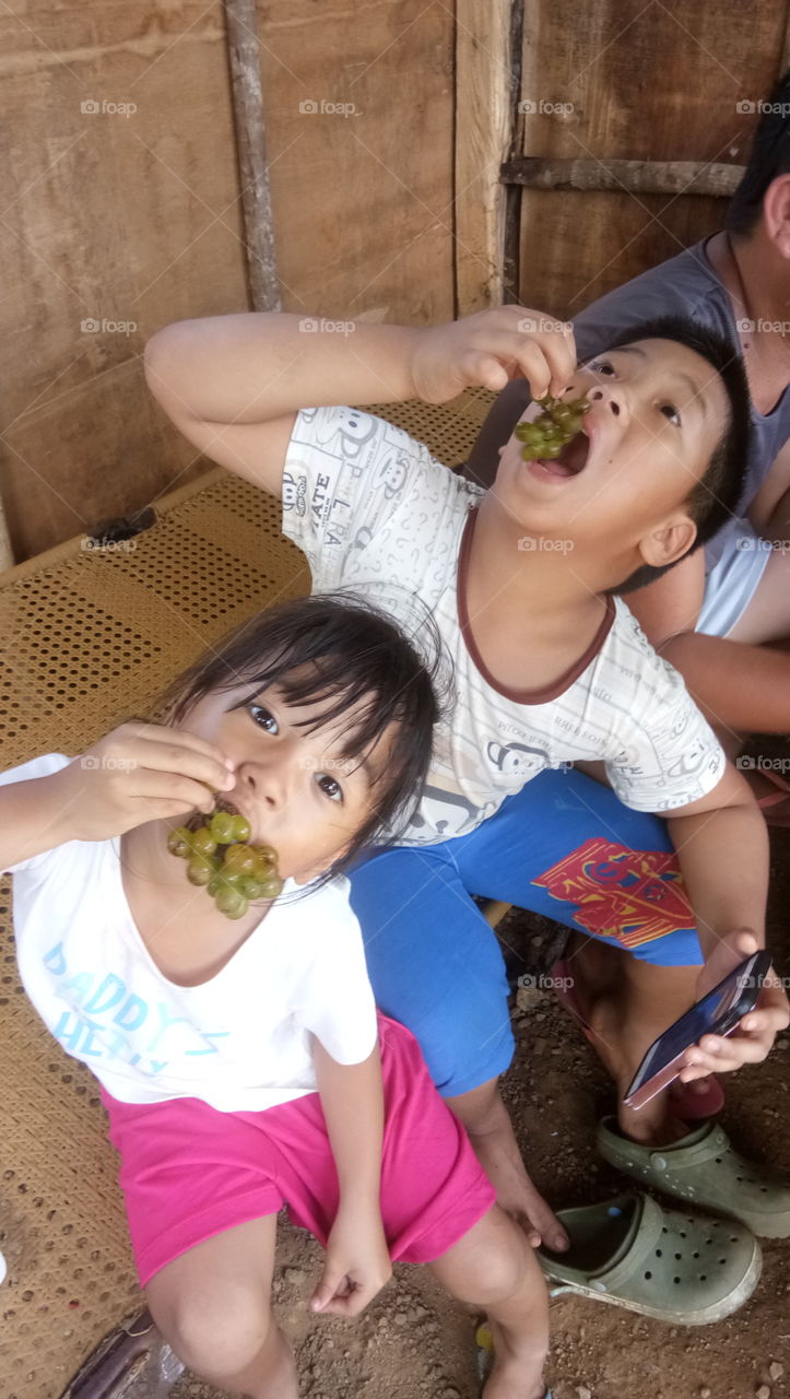 Children Enjoying Grapes