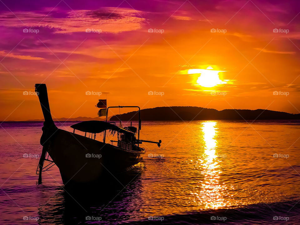 A long tail boat at sunset in Krabi Thailand 