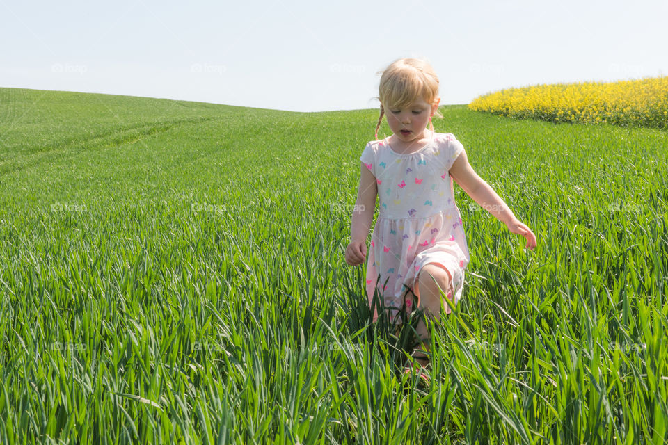 Cute girl walking in grassy field