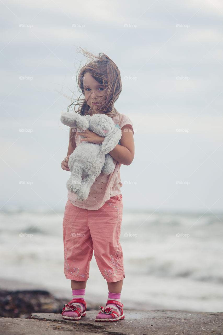 Girl portrait near sea a windy day