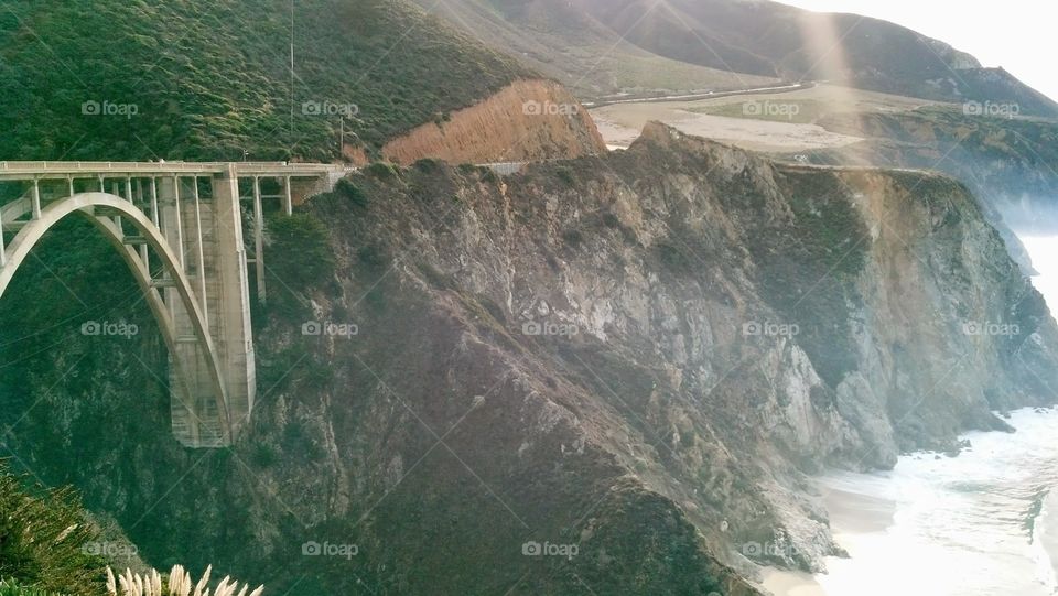 Bixby creek bridge at rocky mountains by sea