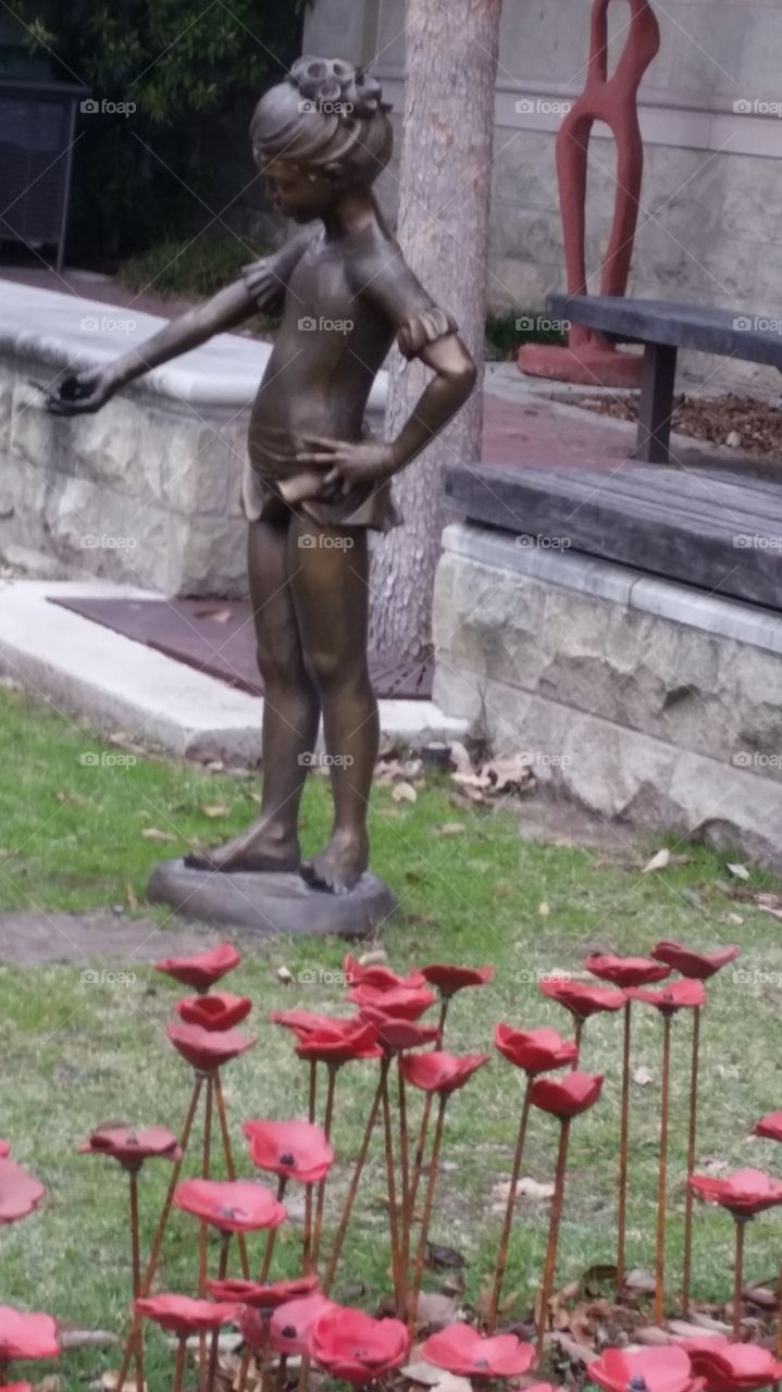 red poppies art and child sculpture