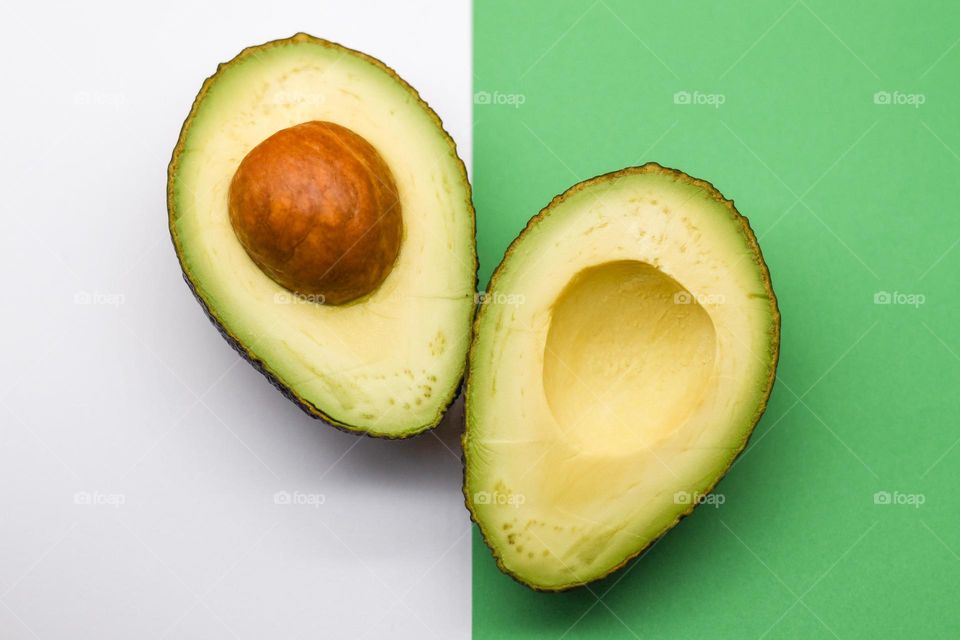 Avocado on white and green