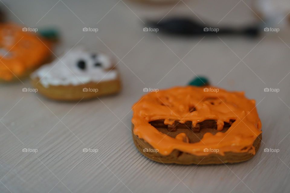 seven year old boy decorating handmade cookies for Halloween