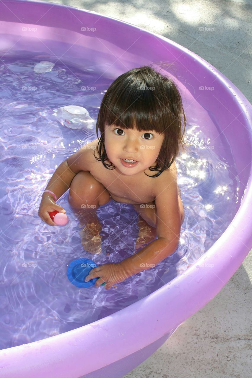 Asian girl enjoying in water tub
