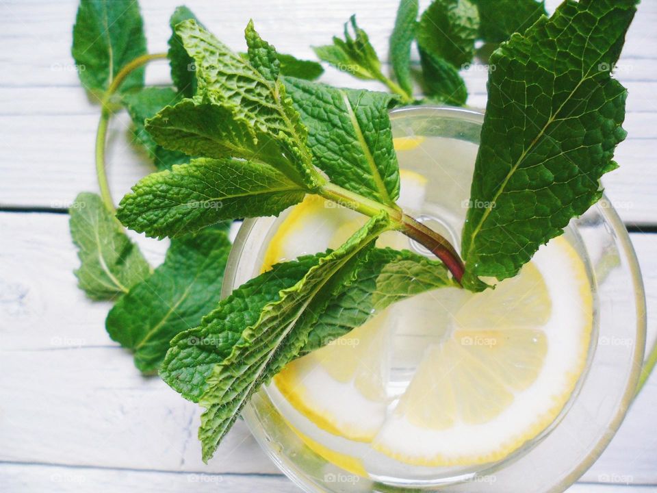 Homemade lemonade with lemon and mint leaves