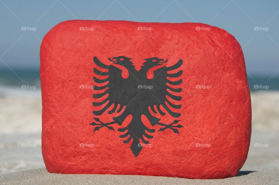Albania, national flag on a stone
