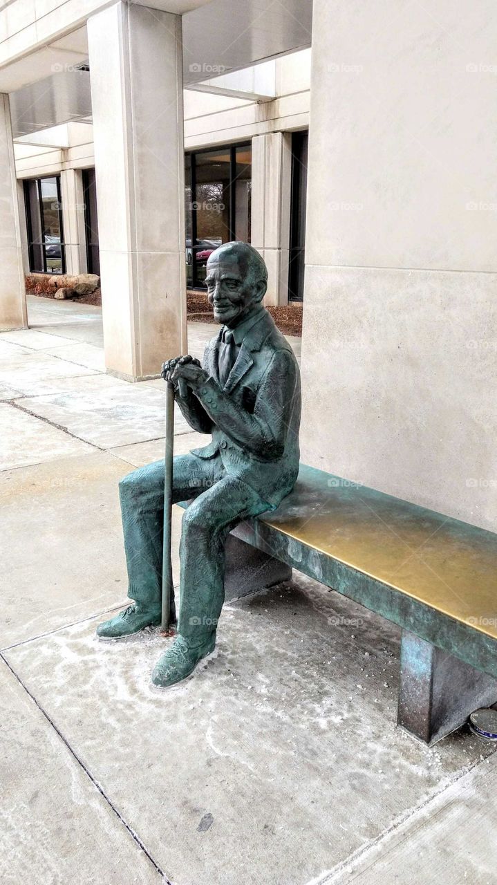 Sitting Man with Cane statue