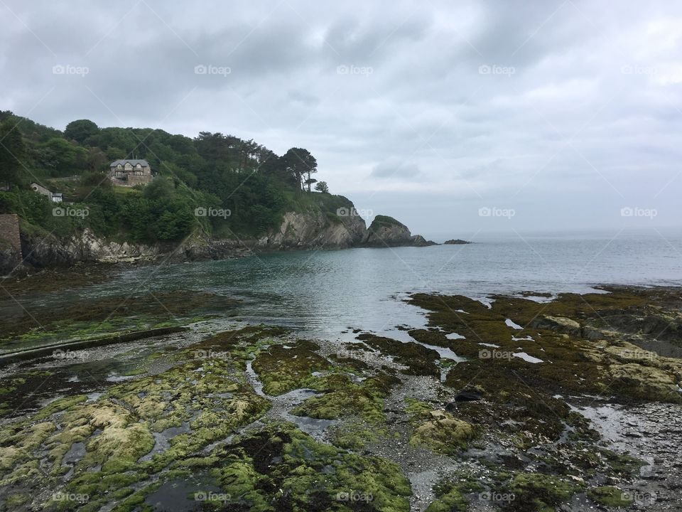 A landscape photo of Lee bay, capturing the land, sea and sky. North Devon in summer. 