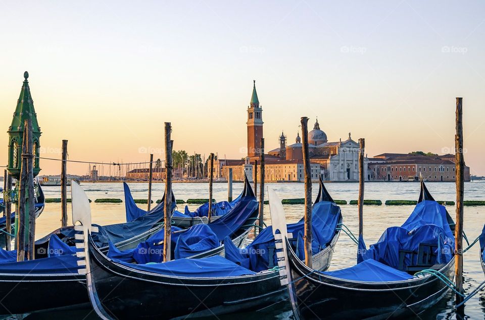 Sunrise View across the gondolas to the church of San Giorgio Maggiore in Venice, Italy