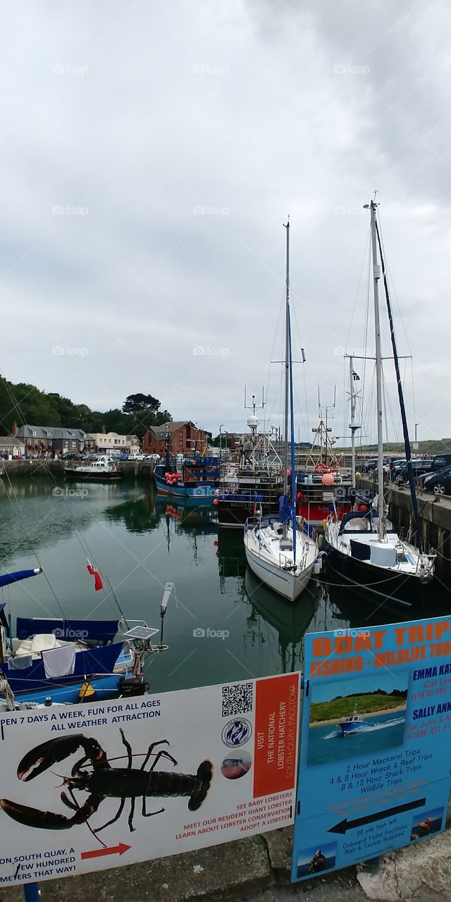view of boats in harbour in small Cornish fishing village