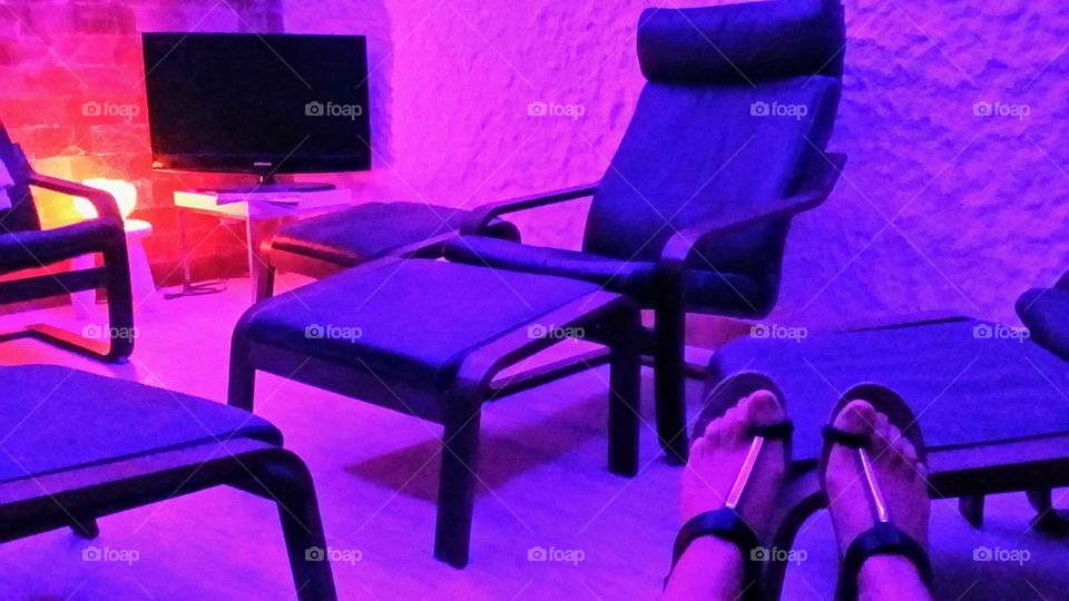 Salt room therapy; walls made of salt with chairs to relaxe with colored lighting