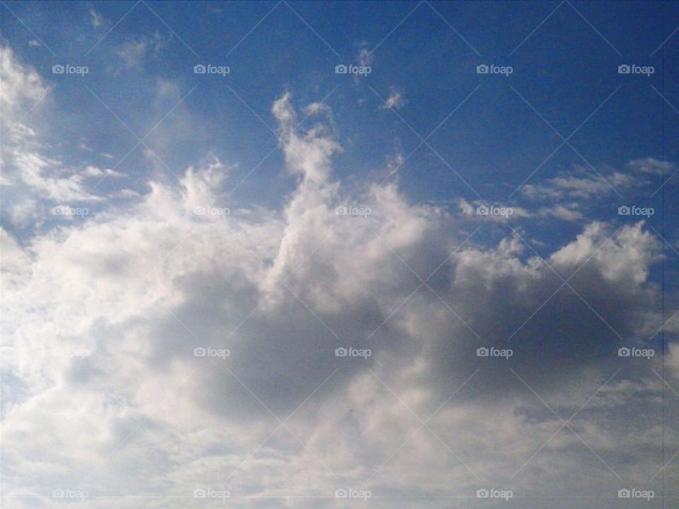 The cloud shaped like a man sitting on the boat.