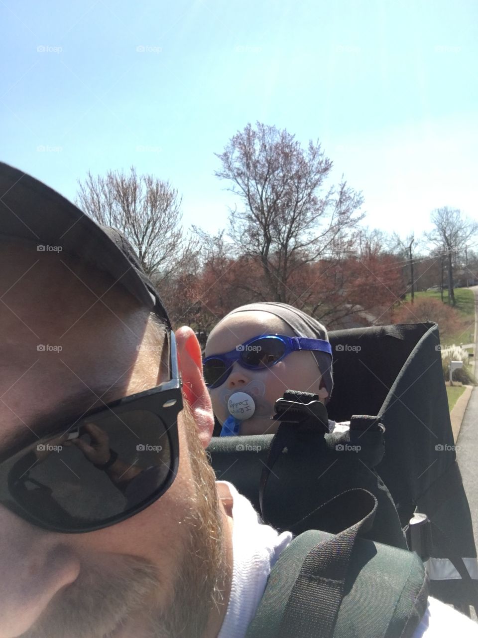 Dad walking with baby in carrier on his back