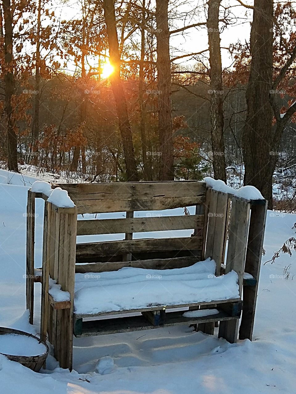 snowy bench at sunset