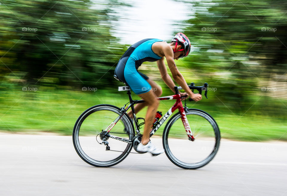 man on a bike in high speed. male contestant on a bike in triathlon in Mali Stapar,Serbia,summer 2014