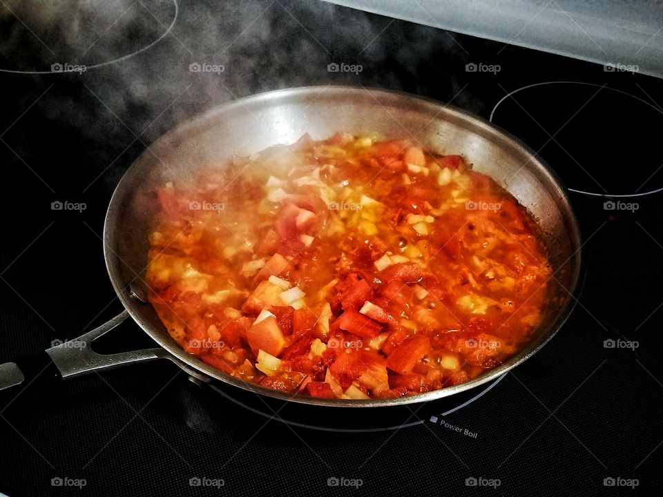 fried tomatoes in skillet on stove top