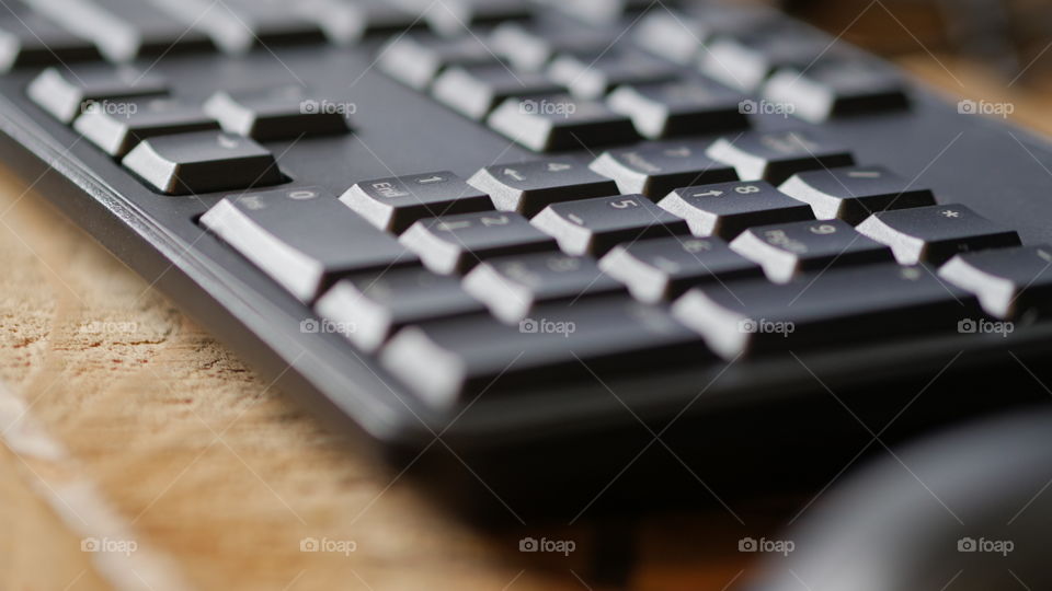 Black keys on a keyboard with a mouse on the side