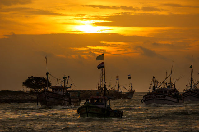 Sailboats on sea at dusk