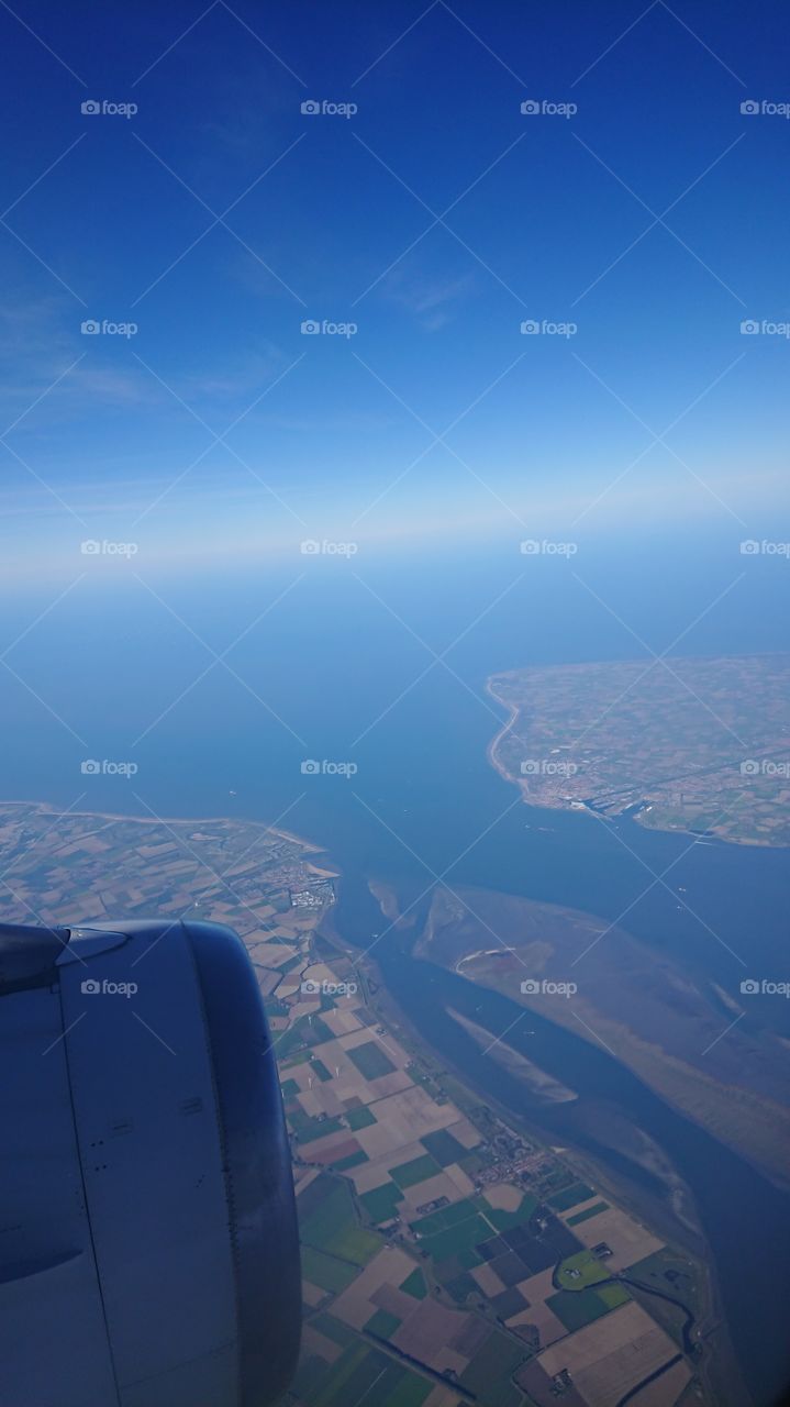 Coastline from plane with blue sky