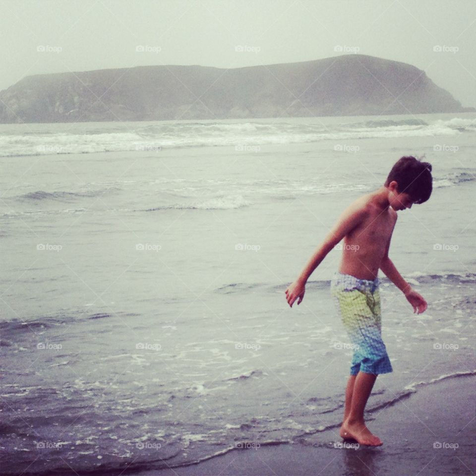 Child playing in the ocean waves