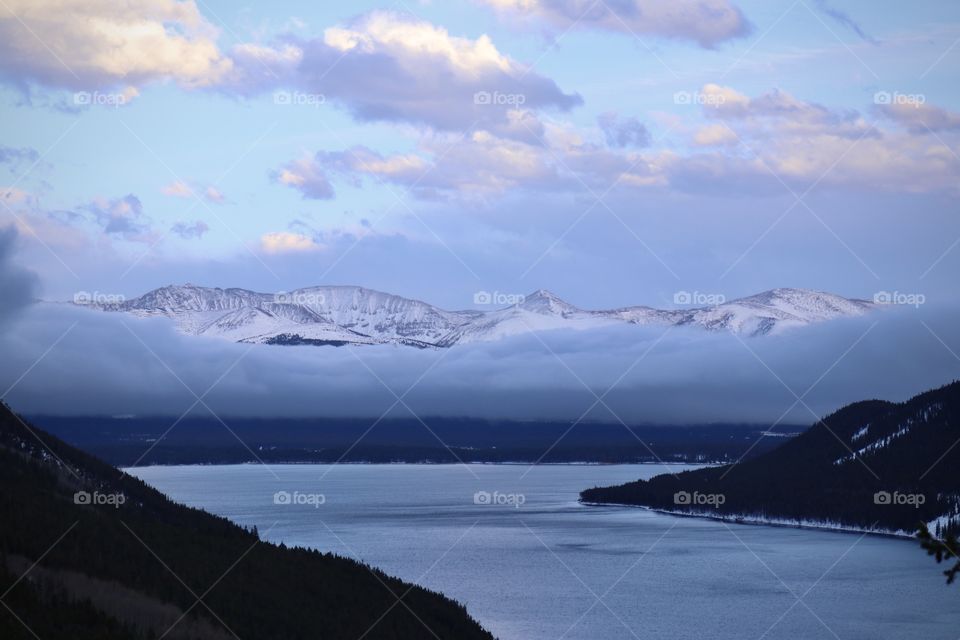Snow covered mountains across the lake.