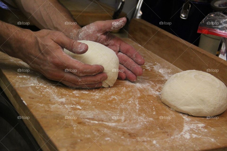 Close-up of hands kneading of dough