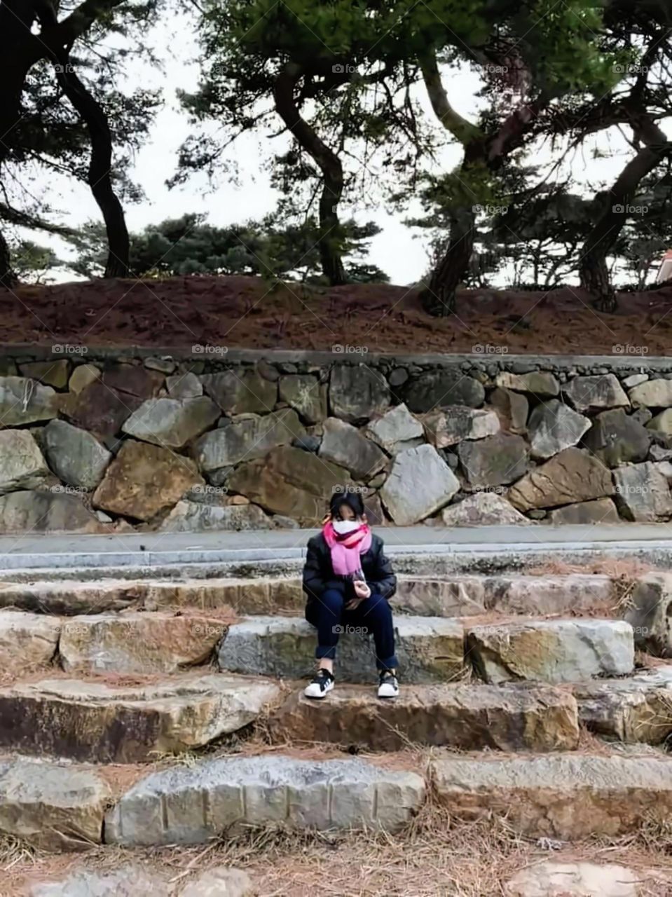 walking around for exercise and  for relaxation.  this place is beside the river.  the  water sounds is like music in her ears.