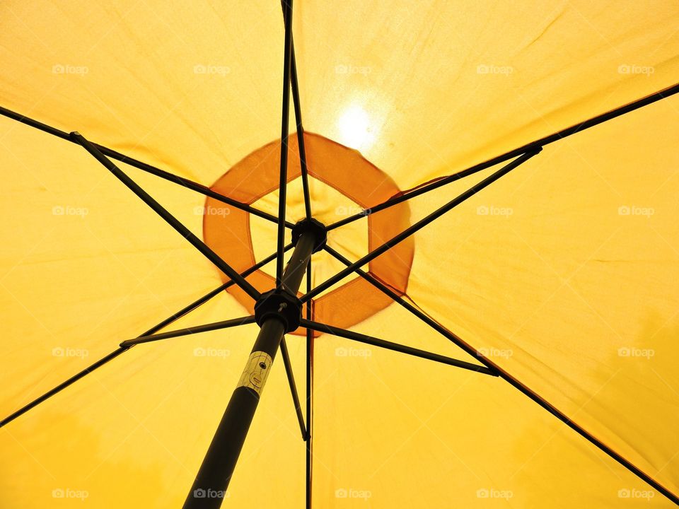 Yellow mellow . Looking up at a yellow umbrella