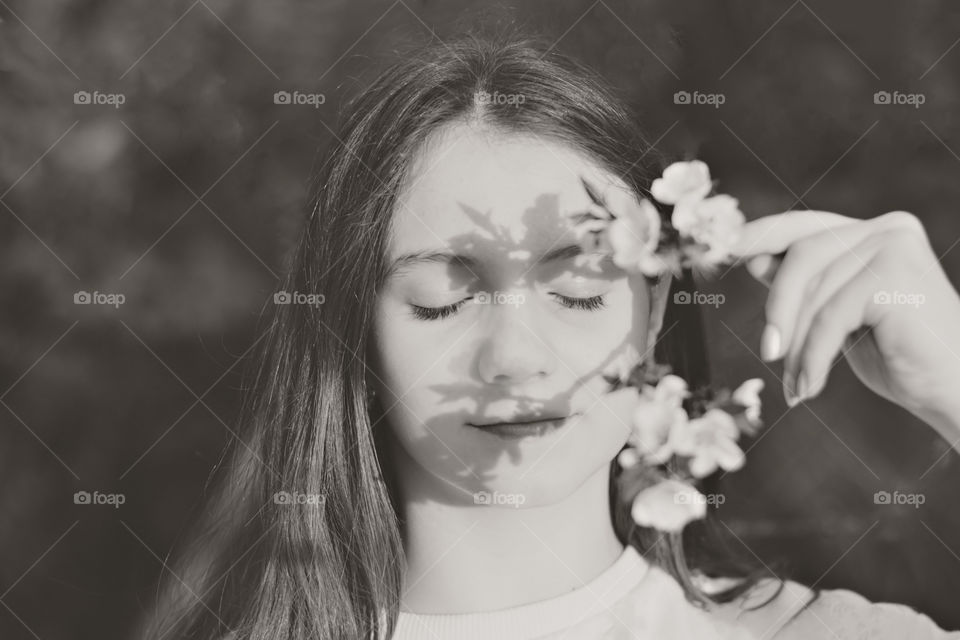 Portrait of girl with flowers in black and white.