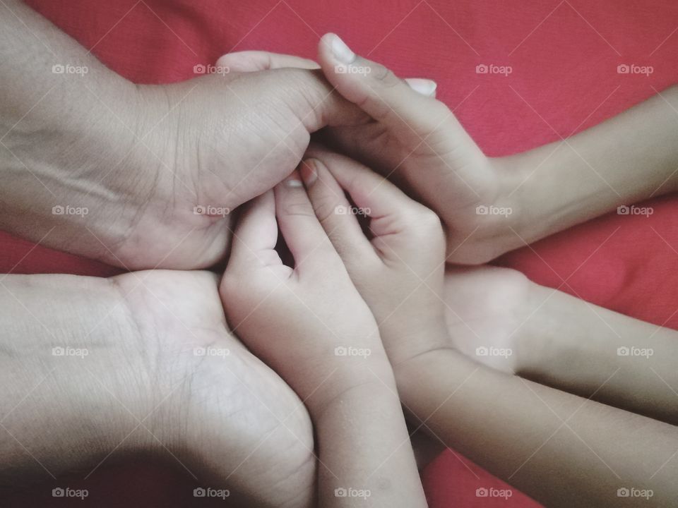 Close-up of mother with child holding hands