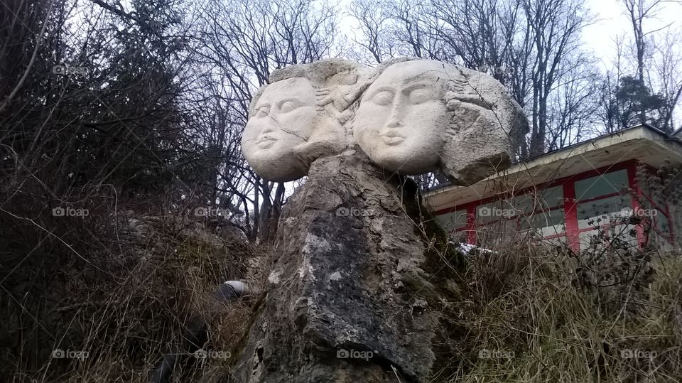 Old statue heads at thermal spa