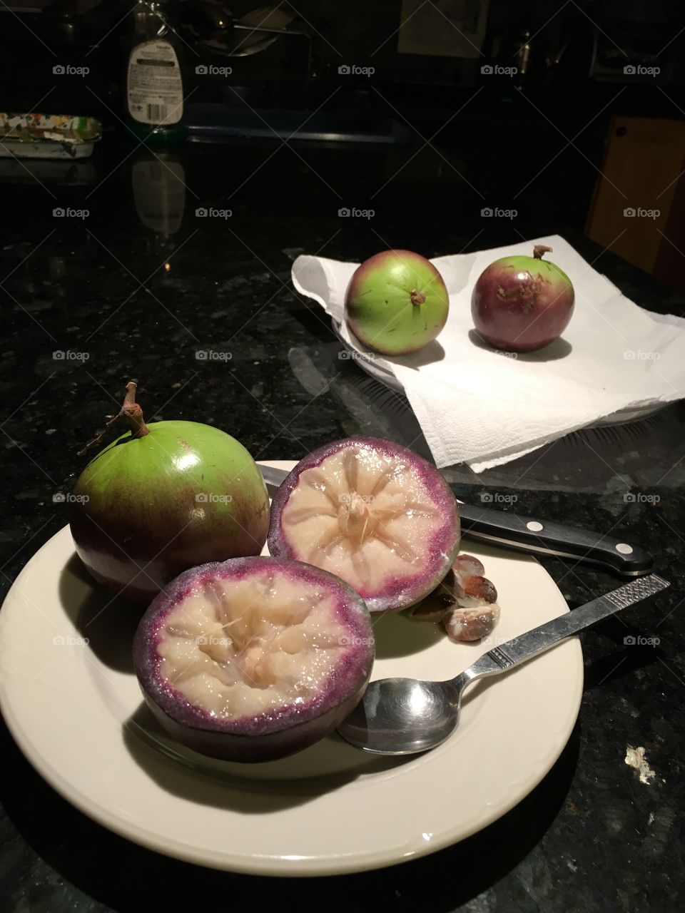 Caimitos--exotic tropical fruit. Purple and green on the outside and a translucent, sweet, milky pulp inside. 