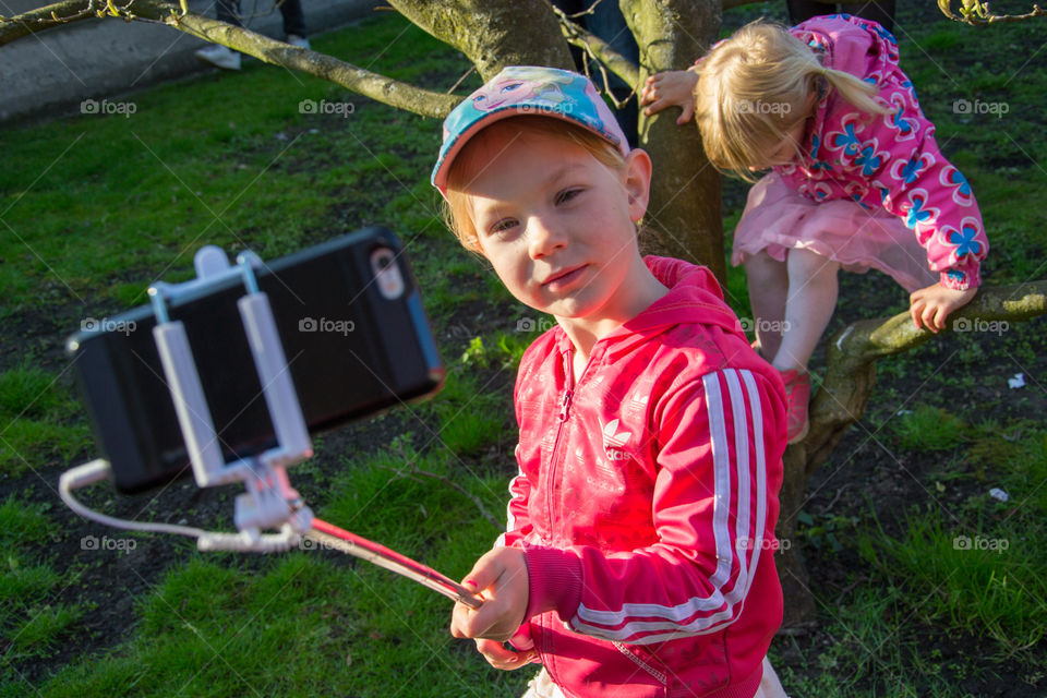 Young girl using a selfiestick to take a selfie in Lund Sweden.