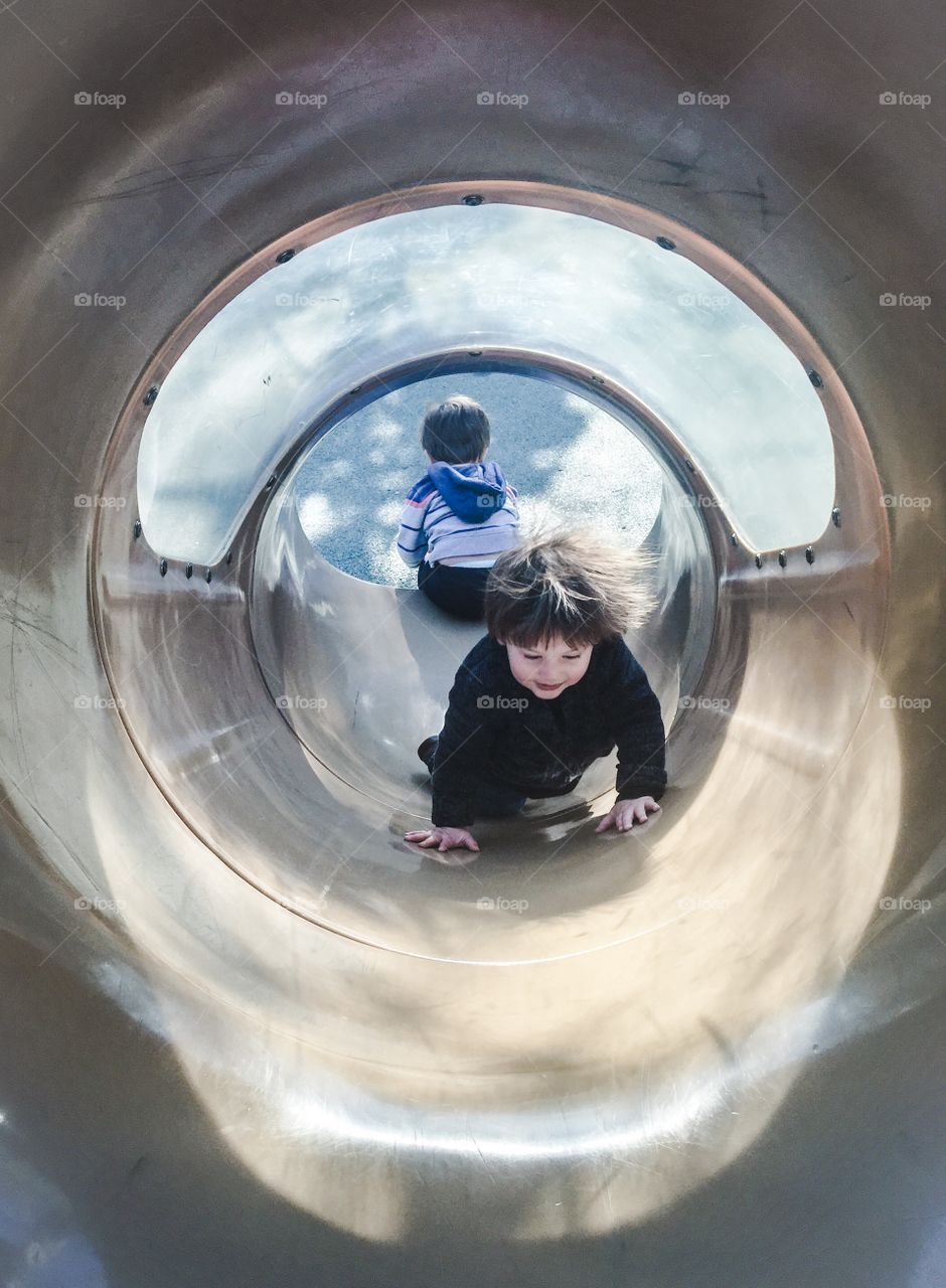 Boy and girl playing on slide