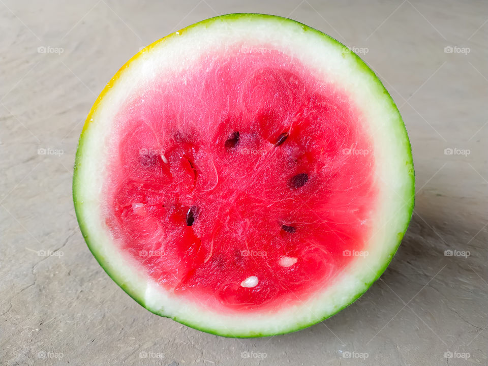 half of fresh watermelon isolated on gray background, flat lay, top view