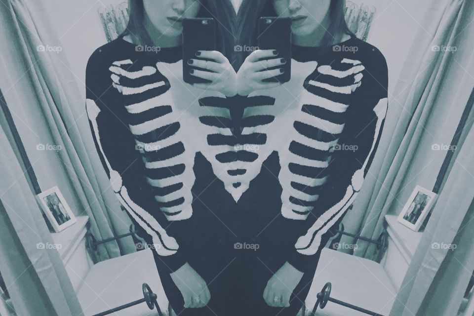 Girl taking selfie in skeleton sweater