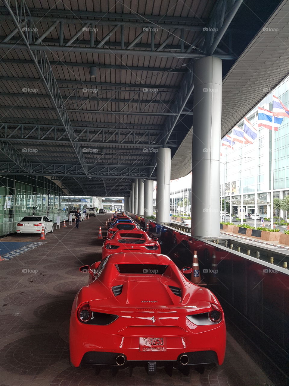 Red Ferrari 488 spider twin-turbocharged V8 luxury sports car parked in line