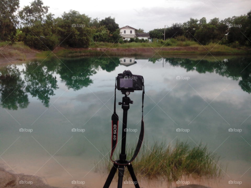 photography set up with tripod over a pond reflection