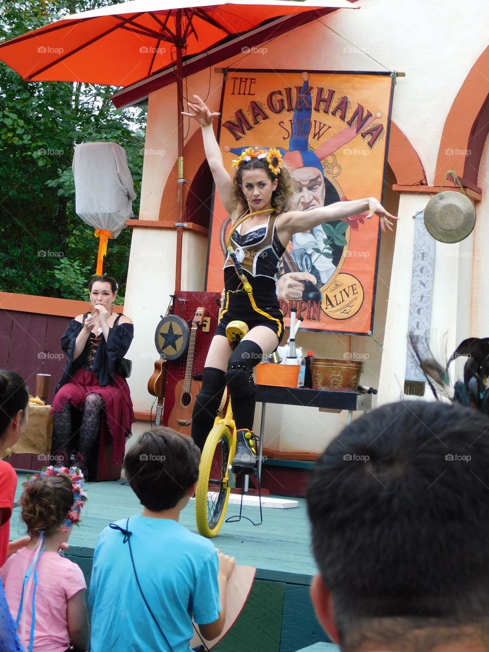 Performer on a unicycle on stage 