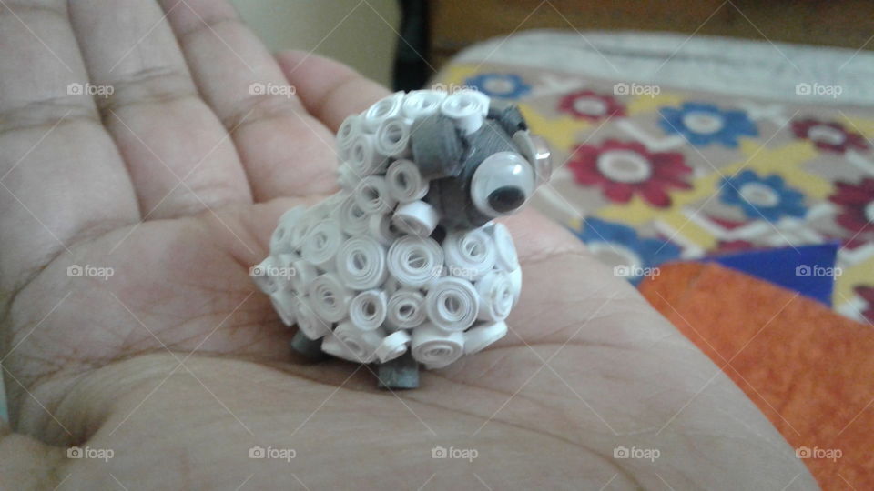 Tiny sheep on hand. Sheep made with quilling strips.