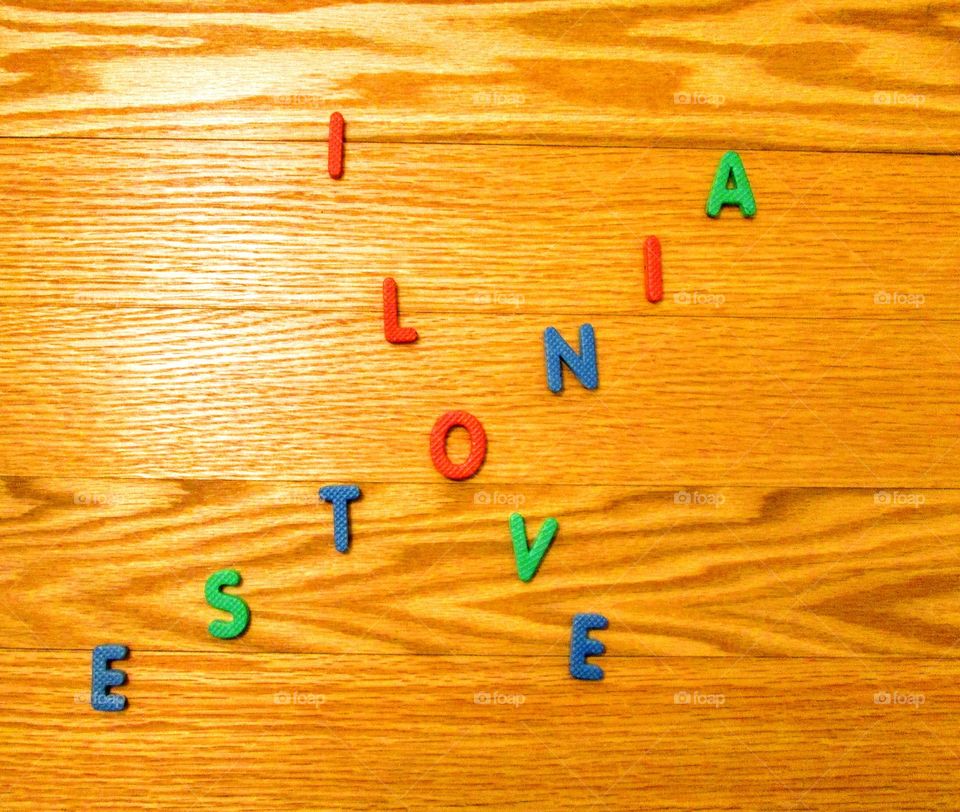 different color letters on wooden planks