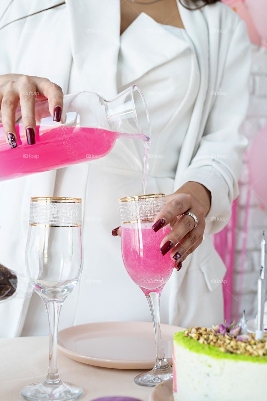 woman drinking pink soda