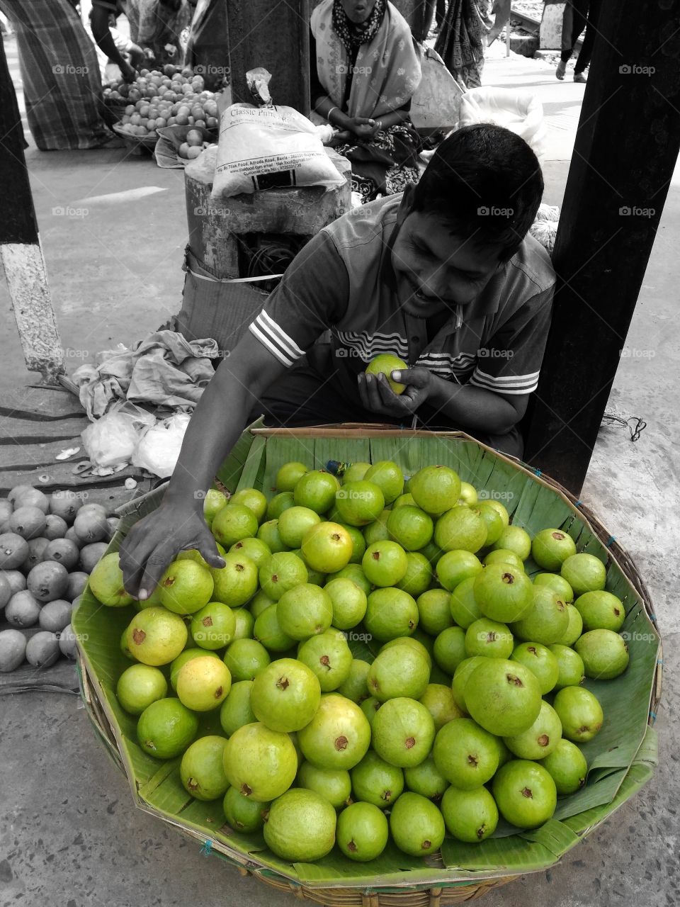 A guy selling guava