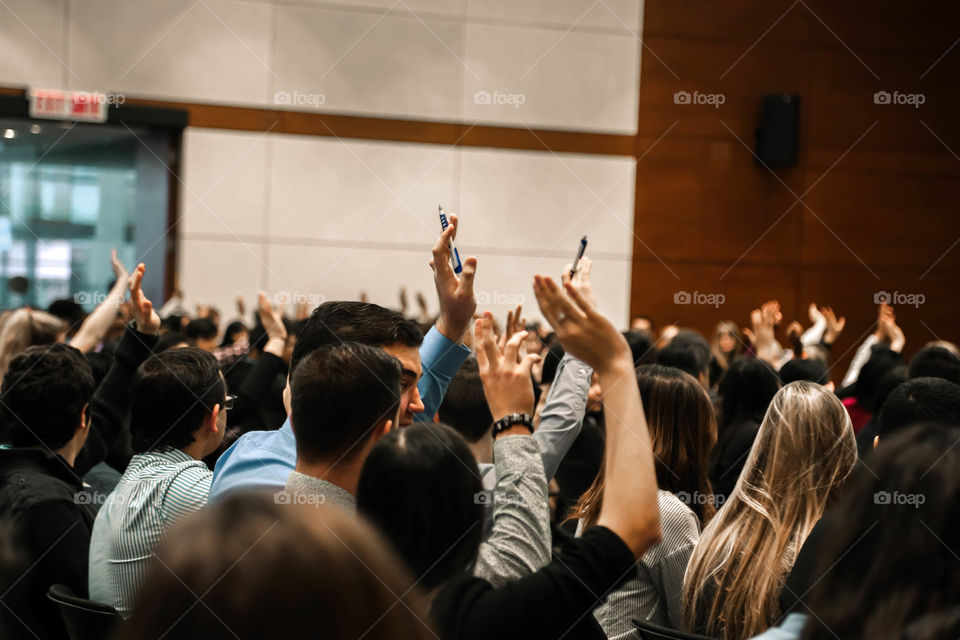 hands up. Photo of the audience at a student business convention