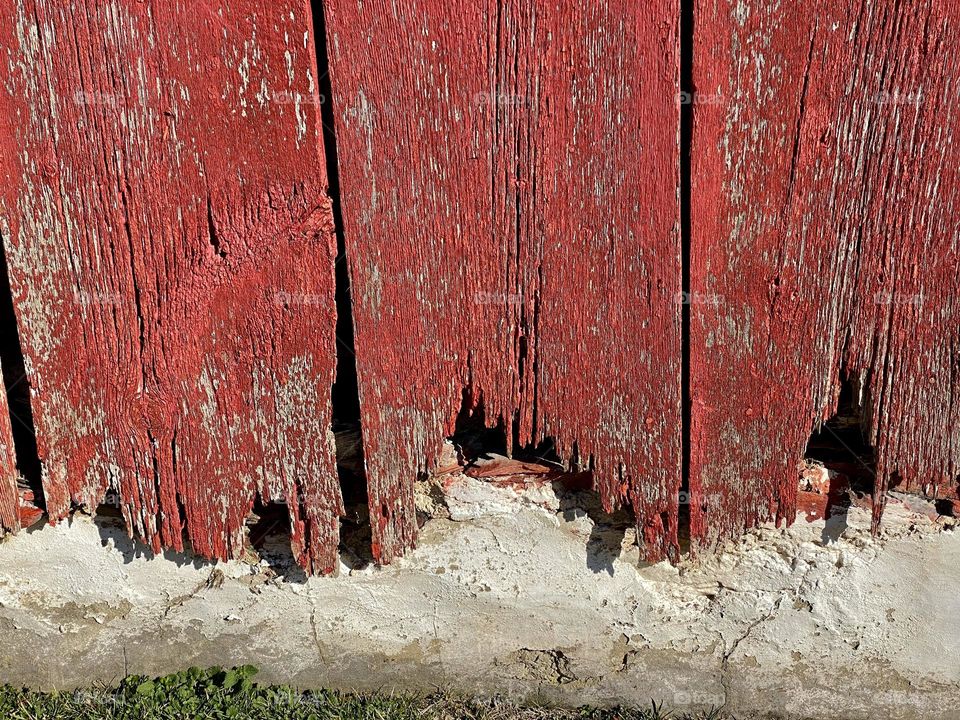The side of an old red barn