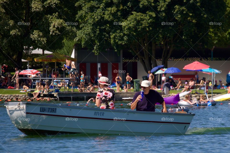 People Having Fun At Lake In Summer