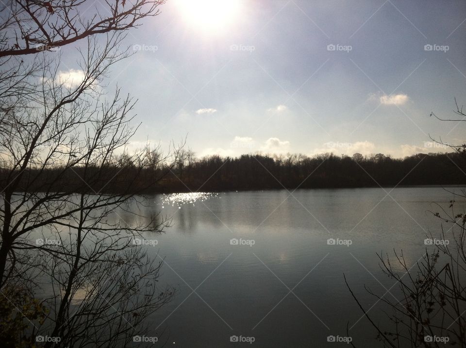 Morning sun on lake in winter. Morning sun reflecting on lake at a park in winter