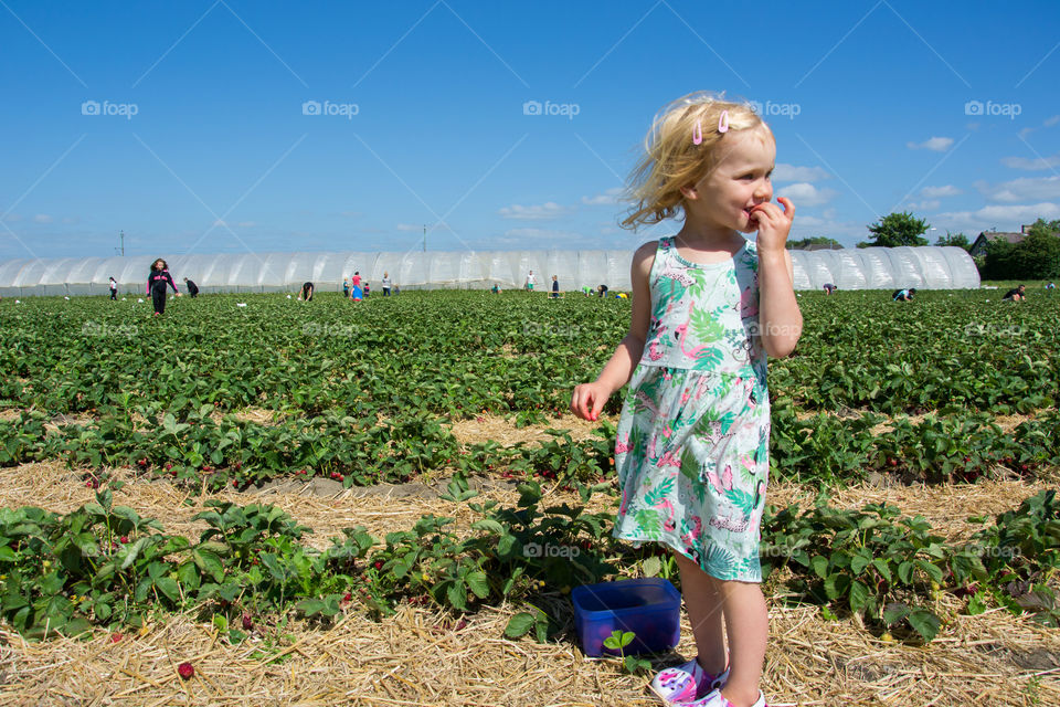 Smiling cute girl standing in field